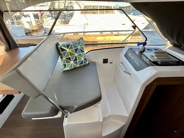Slide: The Image of 2024 Beneteau Antares 9 interior with seating, cushion, and helm station. - 22