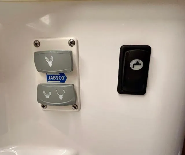 Slide: The Image of Control panel with Jabsco switches and faucet icon in 2024 Beneteau Antares 9 boat. - 28