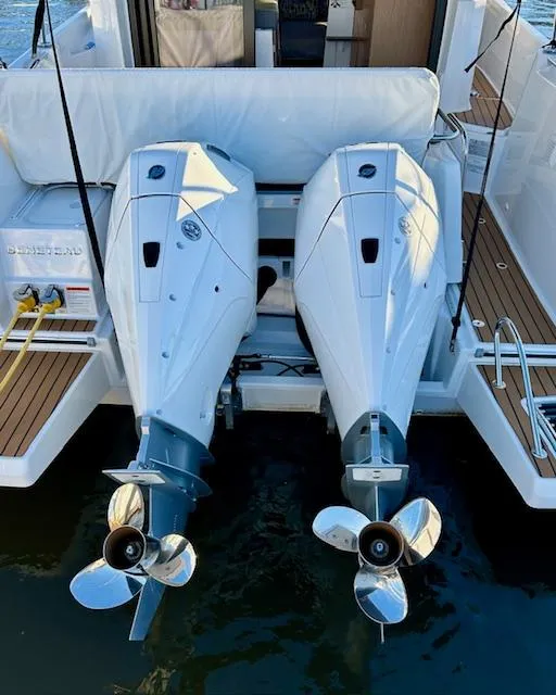 Slide: The Image of 2024 Beneteau Antares 9 with dual outboard engines, rear view on water. - 4