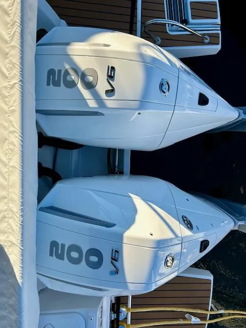 Slide: The Image of Twin V6 engines on a 2024 Beneteau Antares 9 boat, docked with wooden deck. - 5