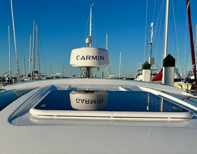 Slide: The Image of 2024 Beneteau Antares 9 with Garmin radar, docked in a marina under clear blue skies. - 8
