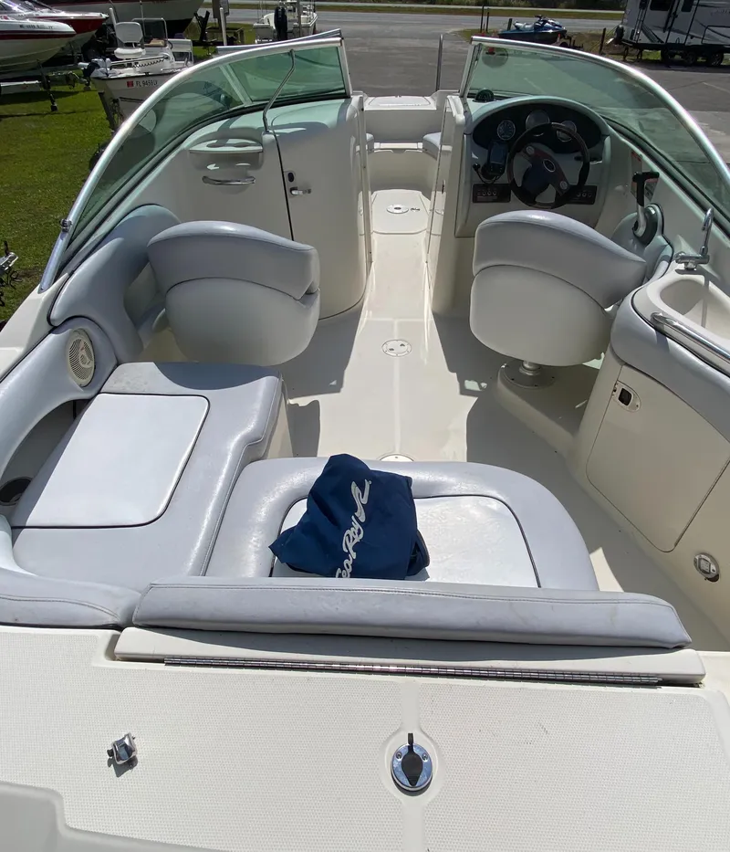 Slide: The Image of 2006 Sea Ray 220 Sundeck boat interior with seating and steering wheel. - 11
