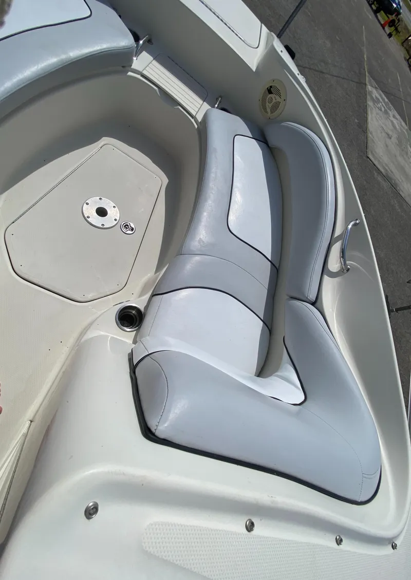 Slide: The Image of 2006 Sea Ray 220 Sundeck boat interior with white cushioned seating. - 12