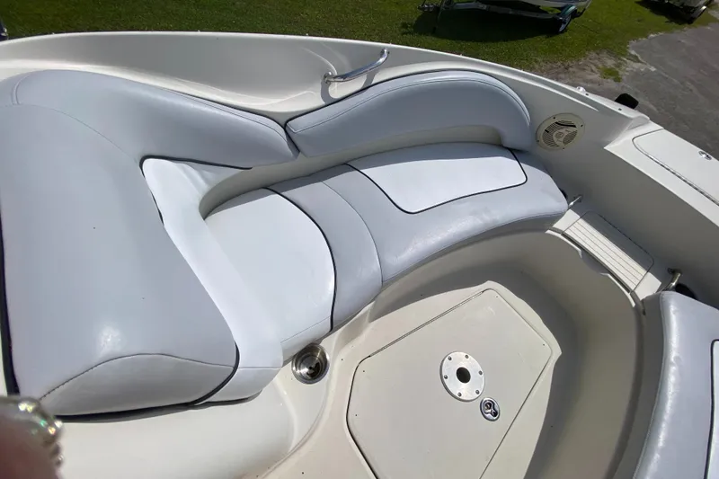 Slide: The Image of 2006 Sea Ray 220 Sundeck boat interior with white cushioned seating. - 13