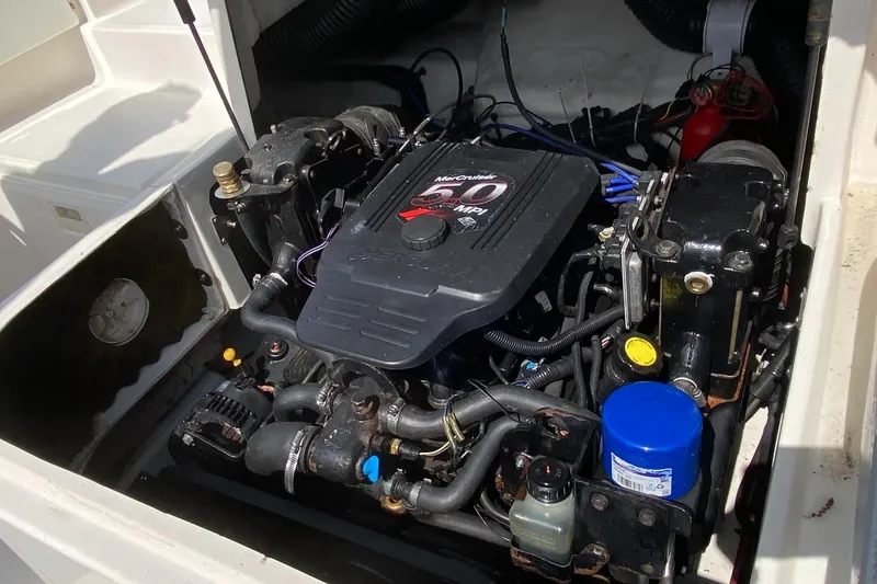 Slide: The Image of Engine compartment of a 2006 Sea Ray 220 Sundeck boat, featuring a MerCruiser engine. - 15