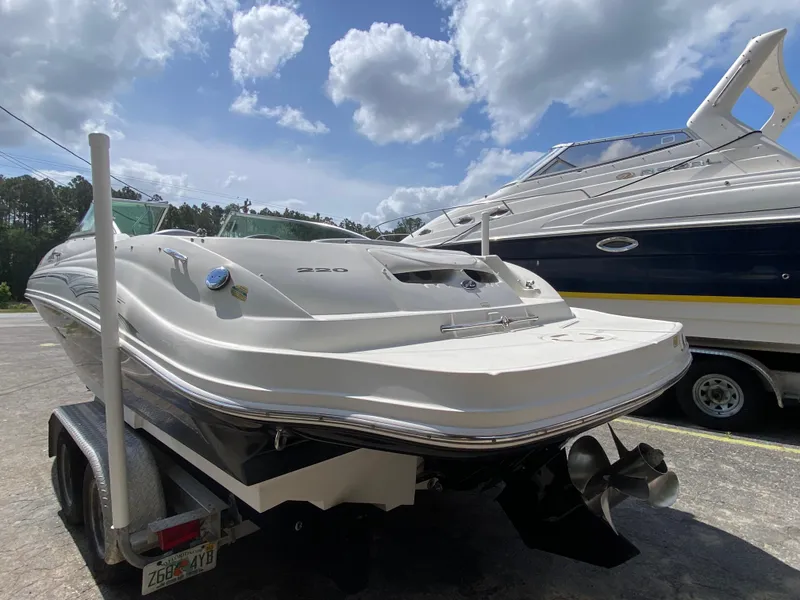 Slide: The Image of 2006 Sea Ray 220 Sundeck boat on trailer under cloudy sky. - 2