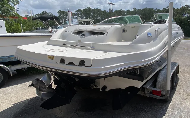Slide: The Image of 2006 Sea Ray 220 Sundeck boat on trailer, rear view, outdoors, sunny day. - 3