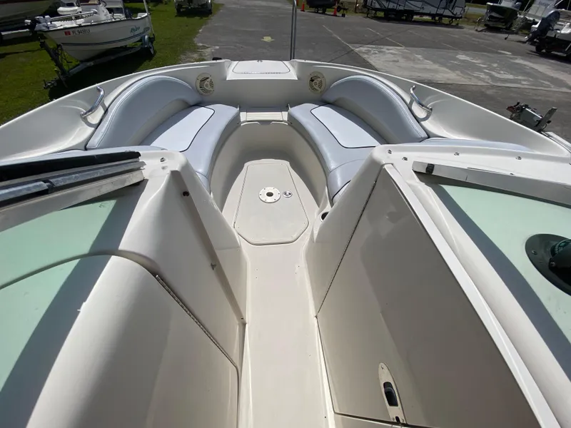 Slide: The Image of 2006 Sea Ray 220 Sundeck boat interior with white seating and open deck layout. - 4