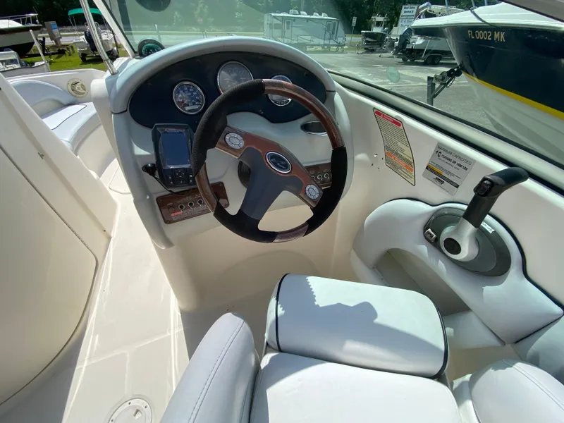 Slide: The Image of 2006 Sea Ray 220 Sundeck boat cockpit with steering wheel and control panel. - 7