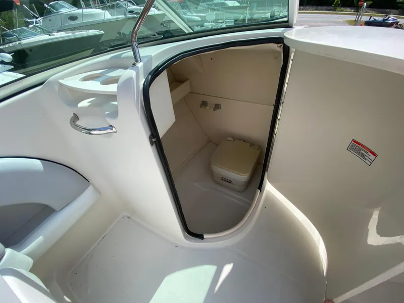 Slide: The Image of 2006 Sea Ray 220 Sundeck boat interior with compact marine toilet. - 8