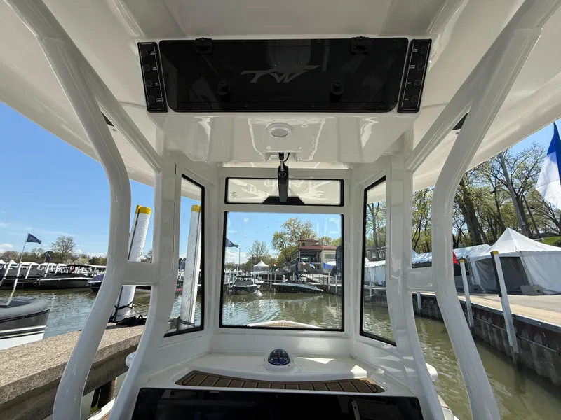 Slide: The Image of 2025 Tidewater 2500 Carolina Bay boat interior with clear view of marina and blue sky. - 4