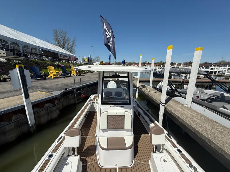 Slide: The Image of 2025 Tidewater 2500 Carolina Bay boat docked at marina under clear blue sky. - 5