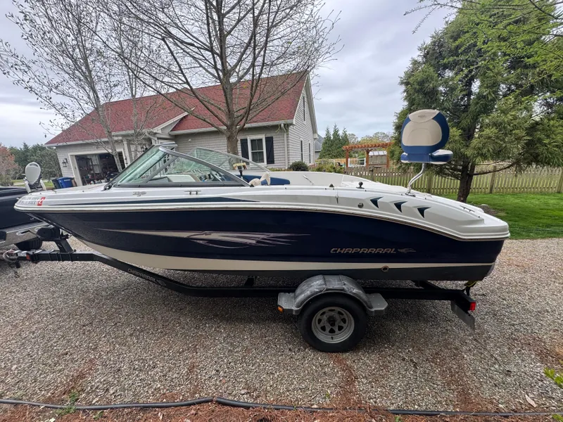 Slide: The Image of 2013 Chaparral 19 Sport H2O boat on trailer, parked in a residential driveway. - 3