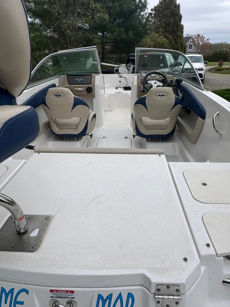 Slide: The Image of 2013 Chaparral 19 Sport H2O boat interior with seating and steering wheel. - 5