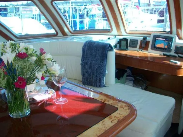 Slide: The Image of Luxurious interior of 2009 Prout 45S yacht with elegant seating and floral arrangement. - 16