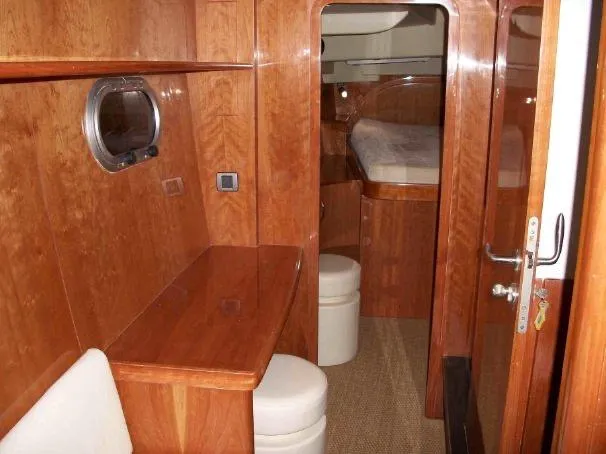 Slide: The Image of Luxurious wooden interior of 2009 Prout 45S yacht cabin with desk and bed. - 22