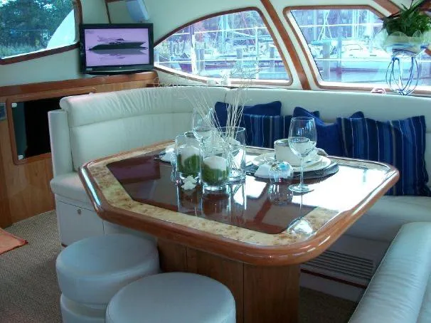 Slide: The Image of Luxurious interior of 2009 Prout 45S yacht with elegant dining area and scenic marina view. - 24
