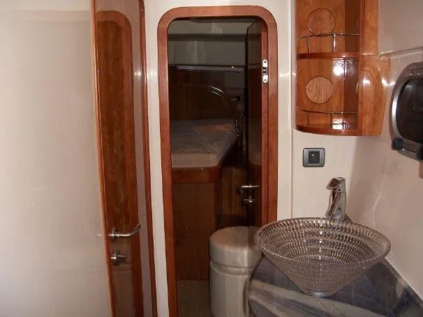 Slide: The Image of Interior of 2009 Prout 45S yacht featuring wooden cabinetry and modern glass sink. - 27