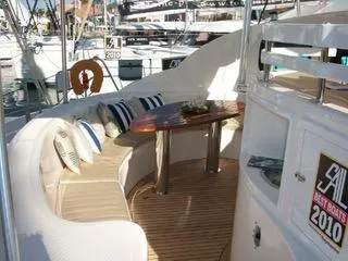 Slide: The Image of Luxurious 2009 Prout 45S yacht interior with cushioned seating and elegant wooden table. - 3