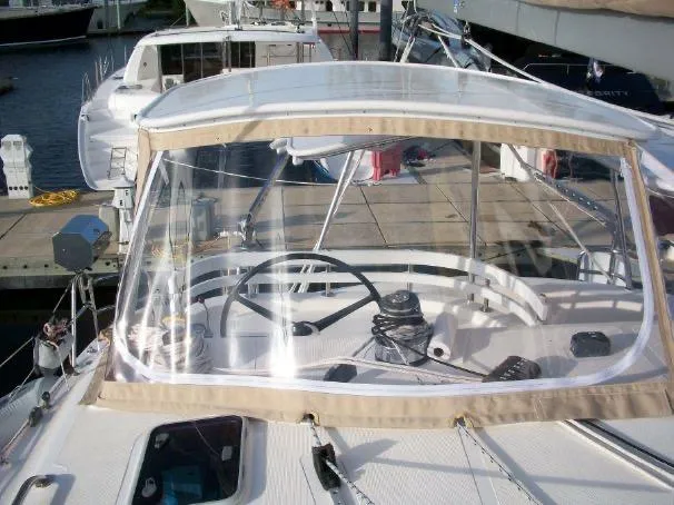 Slide: The Image of 2009 Prout 45S yacht cockpit with clear canopy and steering wheel at marina. - 42