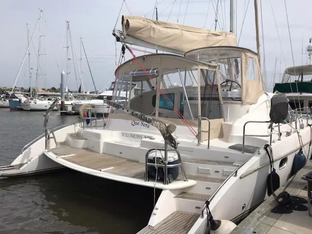 Slide: The Image of 2009 Prout 45S catamaran docked at marina, featuring spacious deck and beige canopy. - 44