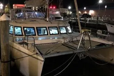 Slide: The Image of 2009 Prout 45S catamaran docked at night, illuminated windows, marina setting. - 74
