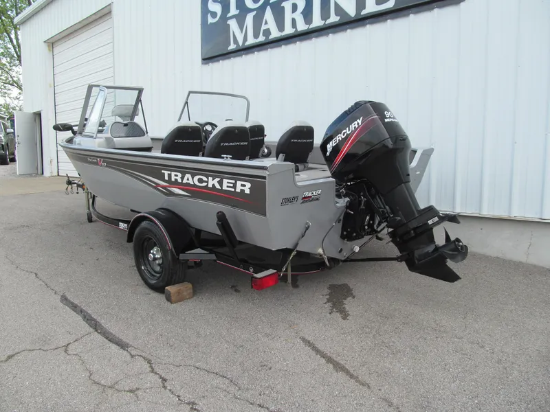 Slide: The Image of 2007 Tracker Pro Guide V-17 WT boat with Mercury outboard motor, parked outside a marine store. - 3