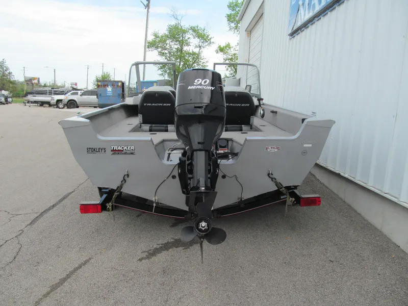 Slide: The Image of 2007 Tracker Pro Guide V-17 WT boat with Mercury 90 engine, parked outdoors. - 4