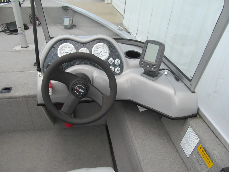 Slide: The Image of 2007 Tracker Pro Guide V-17 WT boat dashboard with steering wheel and gauges. - 6