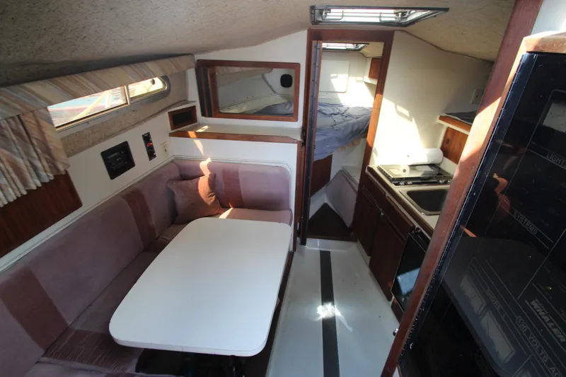 Slide: The Image of Interior of a 1990 Boston Whaler 31 Sportfisherman with dining area and kitchenette. - 15