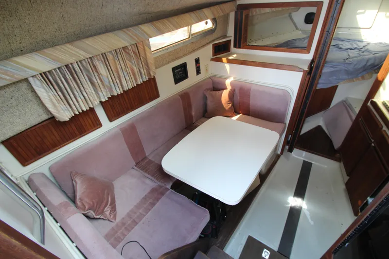 Slide: The Image of Interior of a 1990 Boston Whaler 31 Sportfisherman with cozy seating and dining area. - 17