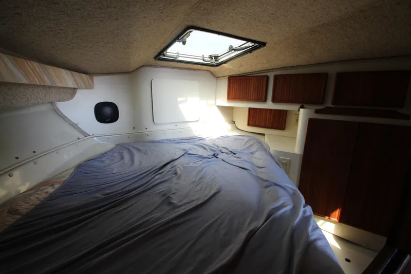 Slide: The Image of Interior cabin of a 1990 Boston Whaler 31 Sportfisherman with bed and storage cabinets. - 23