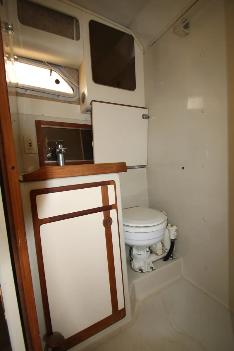 Slide: The Image of 1990 Boston Whaler 31 Sportfisherman boat bathroom with sink and toilet. - 25