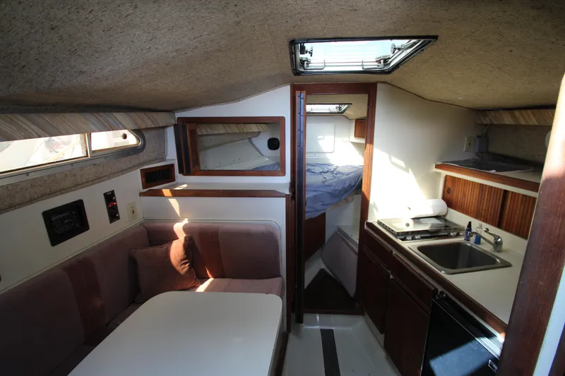 Slide: The Image of Interior of a 1990 Boston Whaler 31 Sportfisherman with kitchenette and seating area. - 29