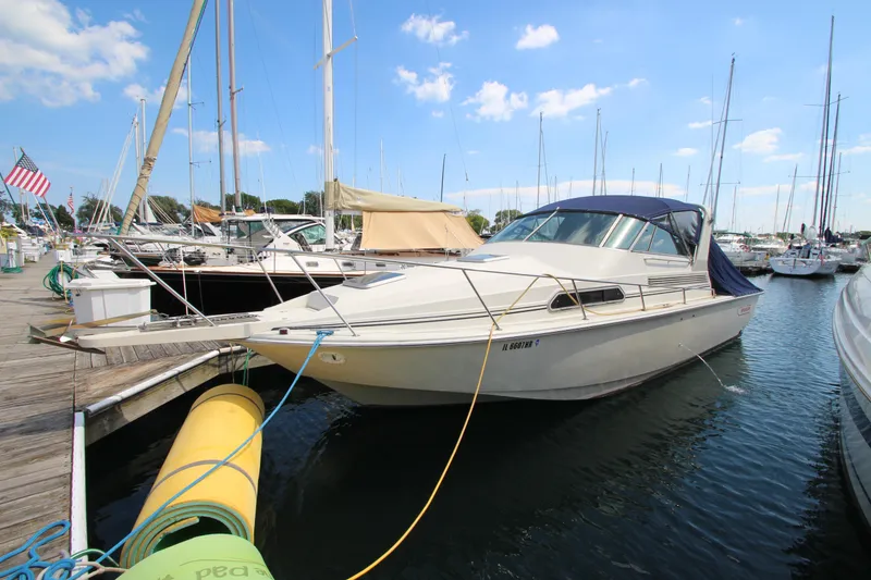 Slide: The Image of 1990 Boston Whaler 31 Sportfisherman docked at marina under blue sky. - 3