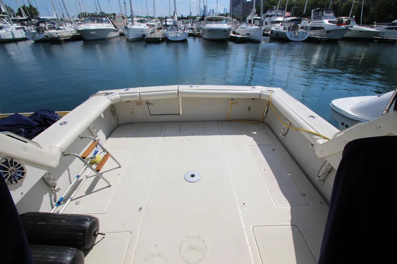 Slide: The Image of 1990 Boston Whaler 31 Sportfisherman boat deck at marina with surrounding yachts. - 4