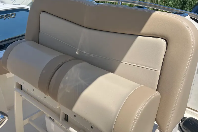 Slide: The Image of 2024 Scout 240 XSF boat seat with beige upholstery and sleek design. - 8