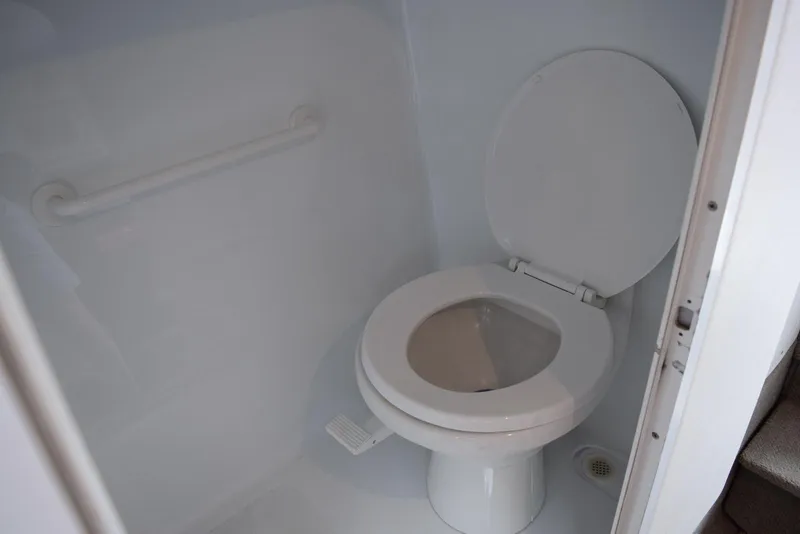 Slide: The Image of Toilet in 2000 Baja 40 Outlaw boat bathroom with white interior. - 10