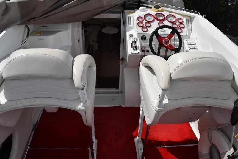 Slide: The Image of 2000 Baja 40 Outlaw boat interior with white seats and red carpet. - 11