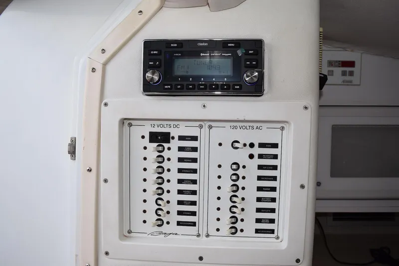 Slide: The Image of Control panel of a 2000 Baja 40 Outlaw boat with stereo system and circuit breakers. - 13