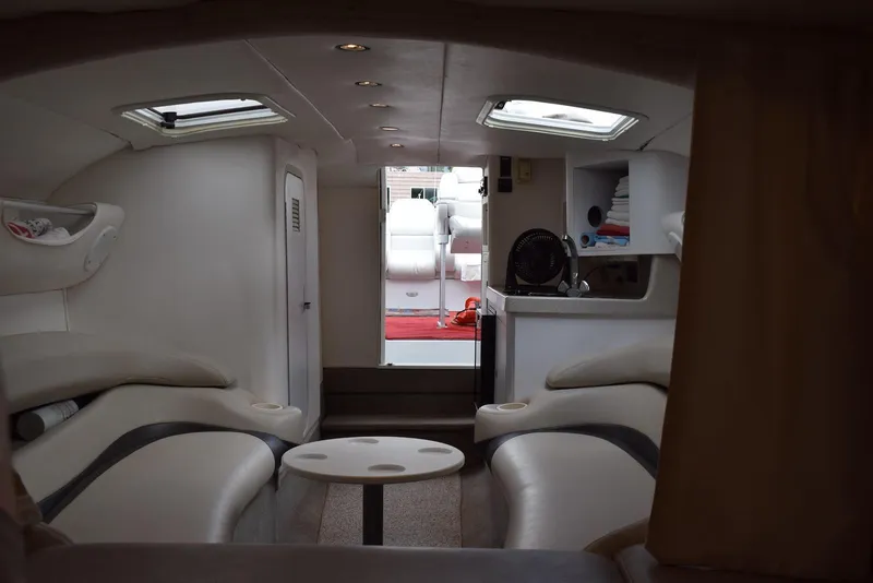 Slide: The Image of Interior of 2000 Baja 40 Outlaw boat with white seating and compact cabin layout. - 6