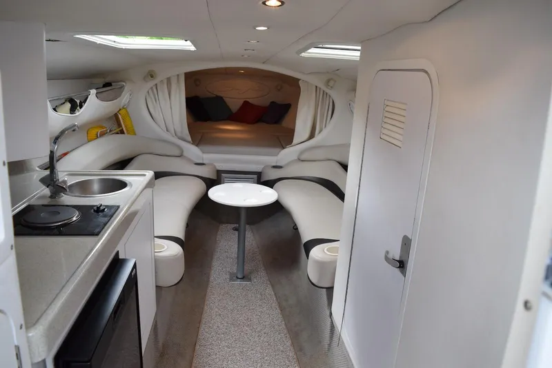 Slide: The Image of Interior of a 2000 Baja 40 Outlaw boat with modern amenities and seating area. - 8