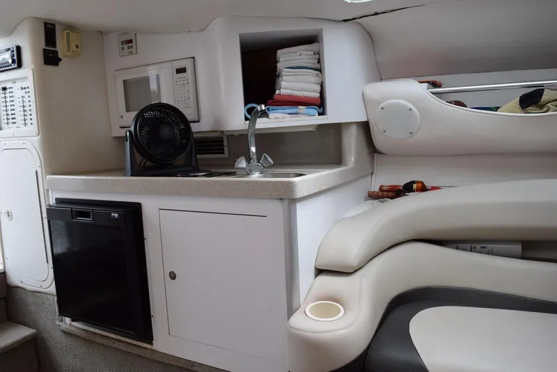 Slide: The Image of 2000 Baja 40 Outlaw boat interior with kitchenette, sink, and seating area. - 9