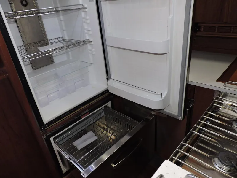 Slide: The Image of Open refrigerator and freezer in 1981 Endeavour 43 yacht kitchen. - 12