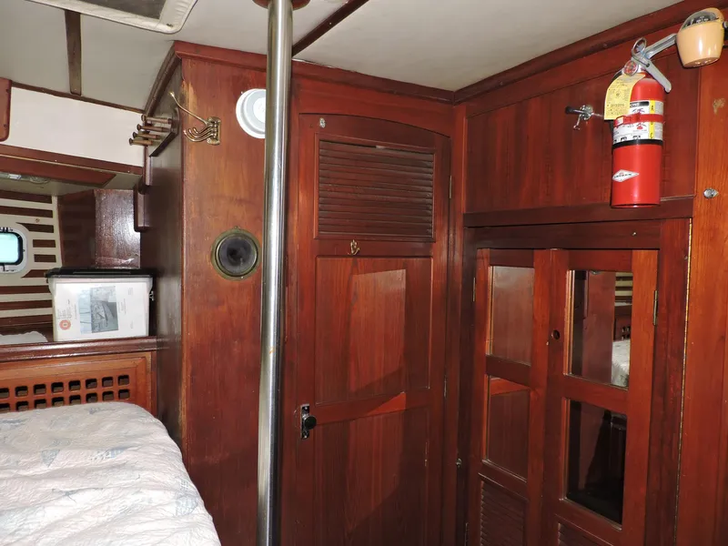 Slide: The Image of Interior of 1981 Endeavour 43 sailboat with wooden cabinetry and fire extinguisher. - 14