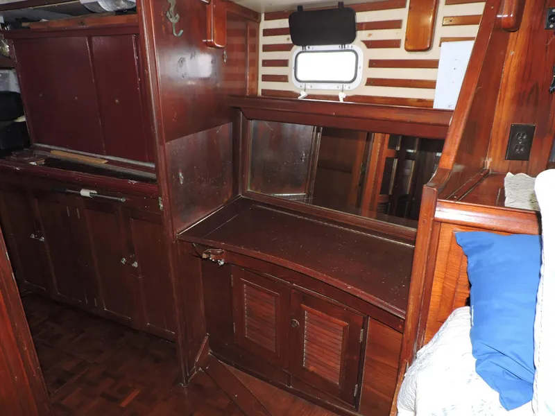 Slide: The Image of 1981 Endeavour 43 yacht interior with wooden cabinetry and small window. - 15