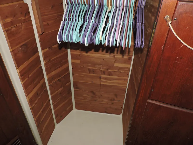 Slide: The Image of Wooden closet interior with colorful hangers, inside a 1981 Endeavour 43 model. - 16