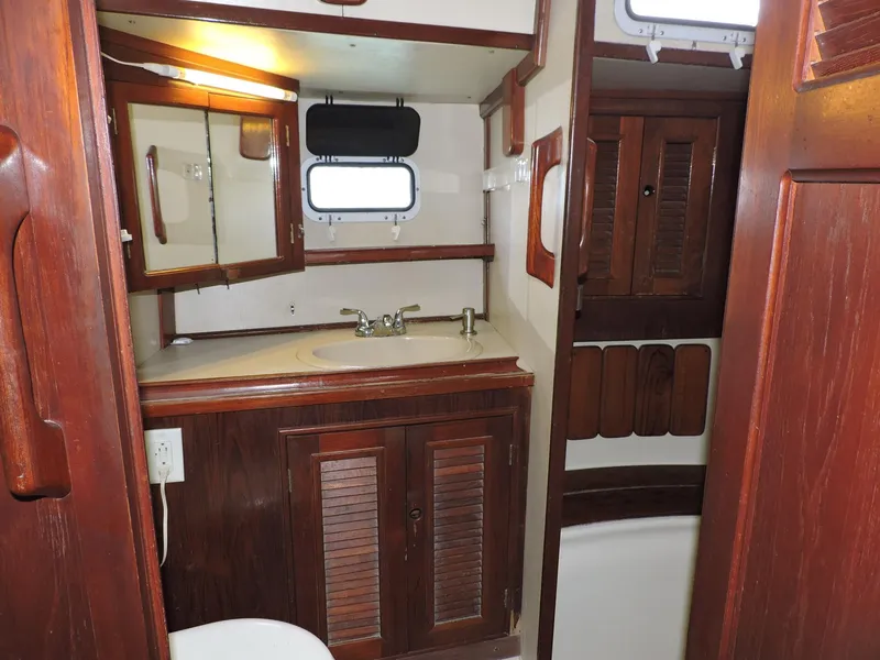 Slide: The Image of 1981 Endeavour 43 yacht bathroom with wooden cabinetry and mirror. - 17