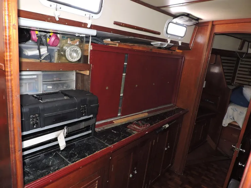 Slide: The Image of Interior of 1981 Endeavour 43 sailboat with storage cabinets and toolboxes. - 23