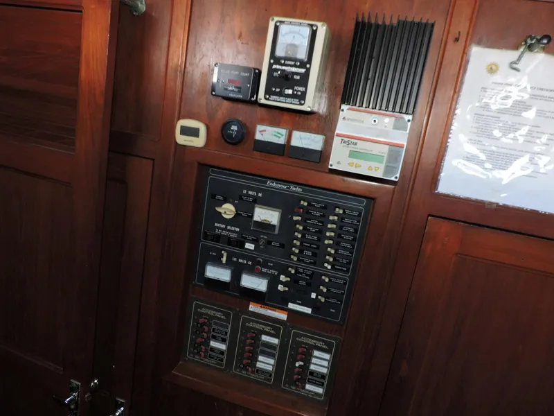 Slide: The Image of Electrical control panel on 1981 Endeavour 43 yacht, featuring various switches and meters. - 24